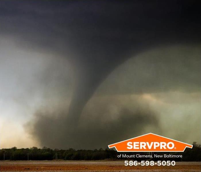 An F3 tornado sets down in a field.