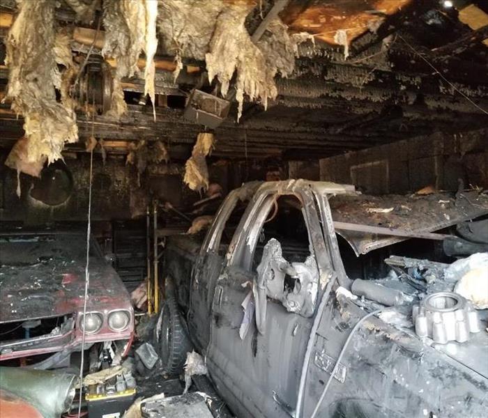 Burned down garage with destroyed car inside