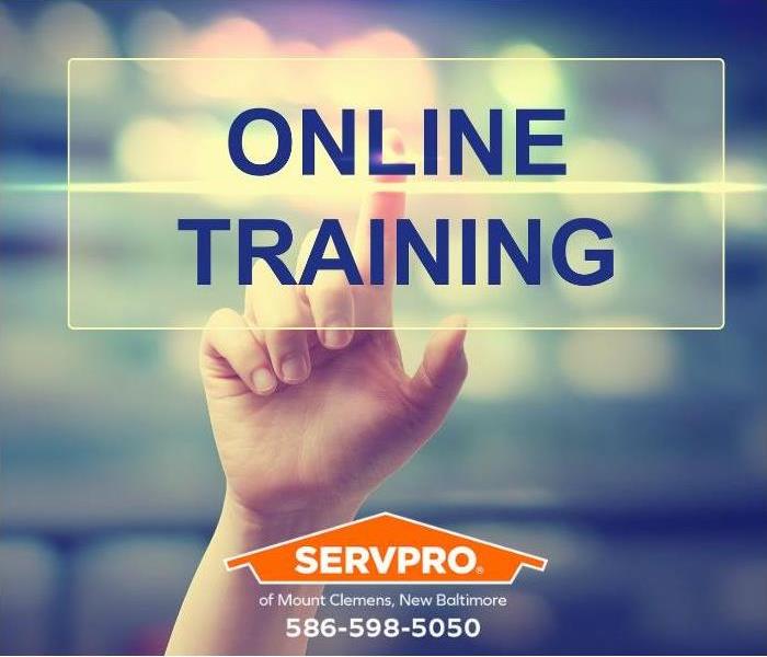 A hand touches the word “online training.”
